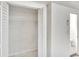 White closet with louvered doors and hanging rod at 5028 School Rd, Land O Lakes, FL 34638