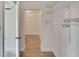 Long closet with double hanging rods and shelving at 5028 School Rd, Land O Lakes, FL 34638
