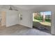 Dining room with tile floors, sliding glass doors and lake view at 5028 School Rd, Land O Lakes, FL 34638