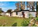 Ranch-style home with landscaping and large yard at 5028 School Rd, Land O Lakes, FL 34638