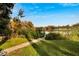Lake access with walkway and lush vegetation at 5028 School Rd, Land O Lakes, FL 34638
