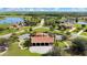 Aerial view of a community with a pavilion, homes, and lakes at 5111 Lake Toscana Dr, Wimauma, FL 33598