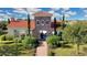 Community clubhouse with a red-tiled roof, stone accents, and walkway leading to the entrance at 5111 Lake Toscana Dr, Wimauma, FL 33598