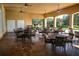 Covered patio area with tables, chairs, and a view of the surrounding landscape at 5111 Lake Toscana Dr, Wimauma, FL 33598
