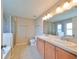 Bathroom with double vanity, large mirror, and shower at 5440 Sandy Shell Dr, Apollo Beach, FL 33572