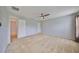 Spacious bedroom with carpeted floor, ceiling fan and en-suite bathroom at 5440 Sandy Shell Dr, Apollo Beach, FL 33572