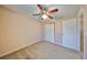 Bedroom with ceiling fan, carpet, and double door closet at 5440 Sandy Shell Dr, Apollo Beach, FL 33572