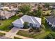 An aerial view of a single-Gathering home in a residential neighborhood at 728 Thistlelake Dr, Venice, FL 34293