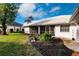 Landscaped backyard with a spacious lawn and mature plants at 728 Thistlelake Dr, Venice, FL 34293