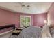 Bright bedroom featuring a king-size bed and plantation shutters at 728 Thistlelake Dr, Venice, FL 34293