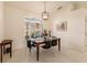 Spacious dining room with large window and modern chandelier at 728 Thistlelake Dr, Venice, FL 34293