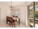 Dining room with wooden table and access to backyard at 728 Thistlelake Dr, Venice, FL 34293