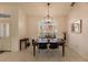Elegant dining area with modern light fixture and large window at 728 Thistlelake Dr, Venice, FL 34293