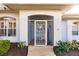 Front entrance with a screened porch and a white metal door at 728 Thistlelake Dr, Venice, FL 34293