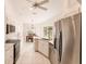 Modern kitchen featuring stainless steel appliances and an island at 728 Thistlelake Dr, Venice, FL 34293