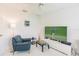 Cozy living room featuring comfortable seating and a large TV at 728 Thistlelake Dr, Venice, FL 34293
