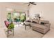 Living room with light walls, sectional sofa, and sliding glass doors at 728 Thistlelake Dr, Venice, FL 34293