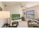 Relaxing living room with comfortable seating and large TV at 728 Thistlelake Dr, Venice, FL 34293