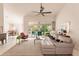 Spacious living room with a sectional sofa, large windows, and a view of the backyard at 728 Thistlelake Dr, Venice, FL 34293