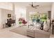Bright living room featuring a sectional sofa and sliding glass doors leading to the backyard at 728 Thistlelake Dr, Venice, FL 34293