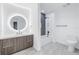 Modern bathroom with gray tile and a large round mirror at 777 3Rd N Ave # 1607, St Petersburg, FL 33701