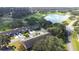 Aerial view showing homes near a golf course and lake at 8041 Green Pines Ter, Spring Hill, FL 34606