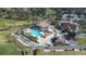 Aerial view of community clubhouse, pool, and golf course at 8041 Green Pines Ter, Spring Hill, FL 34606