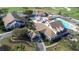 Aerial view of community clubhouse, pool, and golf course at 8041 Green Pines Ter, Spring Hill, FL 34606