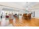 Bright dining room with hardwood floors and view into the kitchen and living areas at 8041 Green Pines Ter, Spring Hill, FL 34606
