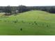 Aerial view of a driving range with golfers practicing at 8041 Green Pines Ter, Spring Hill, FL 34606