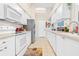 Modern kitchen with white cabinets, stainless steel appliances, and ample counter space at 8041 Green Pines Ter, Spring Hill, FL 34606