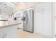 Modern kitchen featuring stainless steel refrigerator and white cabinetry at 8041 Green Pines Ter, Spring Hill, FL 34606