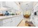 Open kitchen with white cabinets, stainless steel appliances, and breakfast nook at 8041 Green Pines Ter, Spring Hill, FL 34606