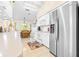 Bright kitchen with white cabinets, stainless steel appliances, and view to dining area at 8041 Green Pines Ter, Spring Hill, FL 34606