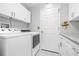 Bright laundry room with washer, dryer, and ample storage at 8041 Green Pines Ter, Spring Hill, FL 34606