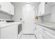 Laundry room with washer, dryer, and cabinets at 8041 Green Pines Ter, Spring Hill, FL 34606