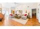 Spacious living room with L-shaped sofa and hardwood floors at 8041 Green Pines Ter, Spring Hill, FL 34606