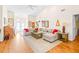 Spacious living room with L-shaped sofa and hardwood floors at 8041 Green Pines Ter, Spring Hill, FL 34606