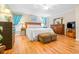 Comfortable main bedroom, featuring wood floors and ample furniture at 8041 Green Pines Ter, Spring Hill, FL 34606