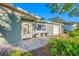 Inviting front porch with light green door and potted plants at 8573 109Th Way, Seminole, FL 33772