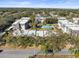 Aerial view showcasing condo building, pool, and street at 8755 Bardmoor Blvd # 105, Seminole, FL 33777