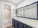 Bathroom with navy blue vanity, large mirror, and tub/shower combo at 8755 Bardmoor Blvd # 105, Seminole, FL 33777