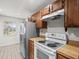 Kitchen with stainless steel appliances and wood cabinets at 8755 Bardmoor Blvd # 105, Seminole, FL 33777