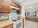 Clean kitchen with white appliances and wood cabinets at 8755 Bardmoor Blvd # 105, Seminole, FL 33777