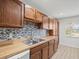 Spacious kitchen with wood cabinets, tile backsplash and flooring at 8755 Bardmoor Blvd # 105, Seminole, FL 33777