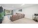Spacious living room with patio access and gray sectional sofa at 8755 Bardmoor Blvd # 105, Seminole, FL 33777