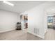 Living area with gray flooring and view into kitchen area at 8755 Bardmoor Blvd # 105, Seminole, FL 33777