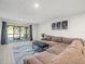 Bright living room featuring a sectional sofa and access to a patio at 8755 Bardmoor Blvd # 105, Seminole, FL 33777