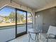 Screened-in patio with small table and chairs, overlooking a grassy area at 8755 Bardmoor Blvd # 105, Seminole, FL 33777