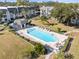 Community pool with lounge chairs and surrounding greenery at 8755 Bardmoor Blvd # 105, Seminole, FL 33777